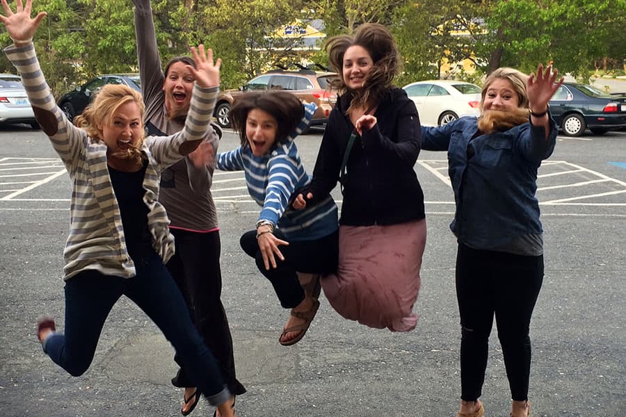 Five Women Jumping in a parking lot